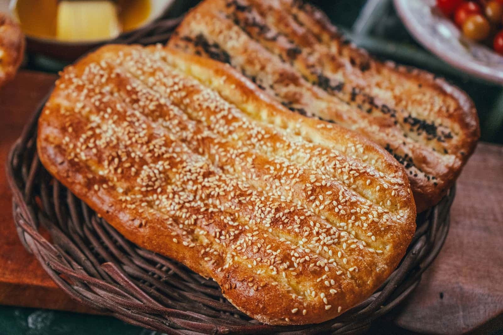 Sesame- and nigella-topped flatbreads in a wicker basket